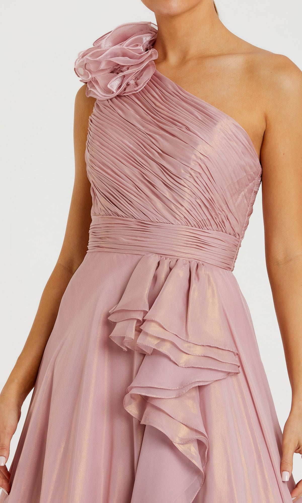 Person wearing a Mac Duggal 49252 long rose gold formal dress with a one-shoulder design, ruched bodice, floral shoulder detail, and layered skirt—an elegant evening gown.